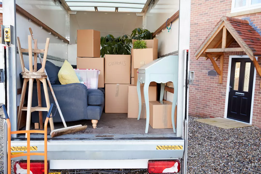 Furniture movers wrapping a sofa in Dubai